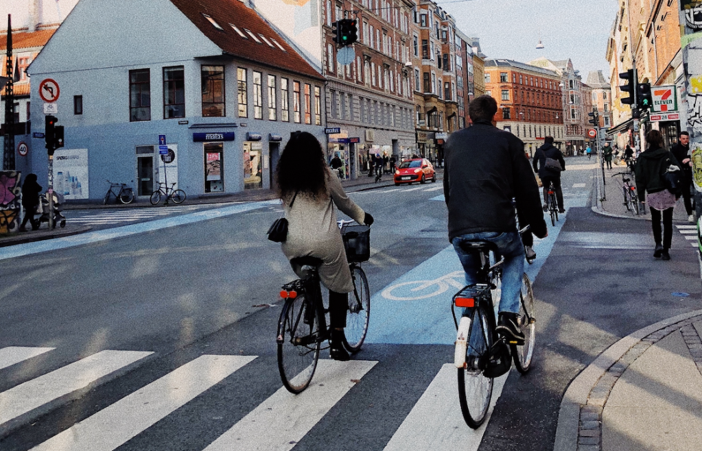 Cyclists using a cycle lane through a city.